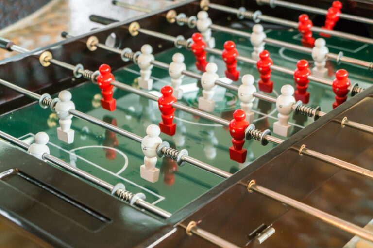 Football table game with red and white player